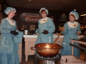 Candy cooks at Silver Dollar City stir the pot, which happens to contain pralines, branson