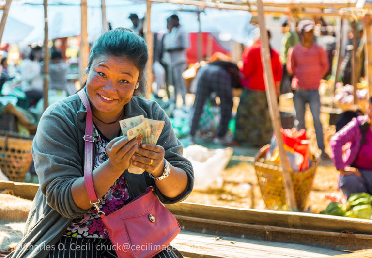 Punakha, Bhutan. Woman Counting her Money in the Fruit and Vegetable Market.