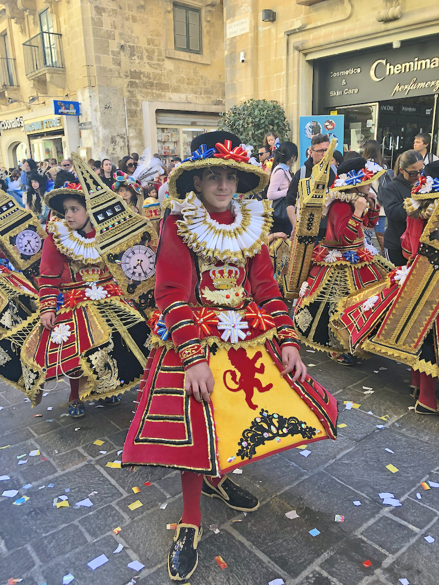Maltese children parade through the streets during Carnival