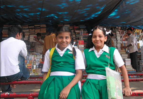 School girls browse the shops near Colaba Causeway on the way home from class, Silk in Mumbai India 