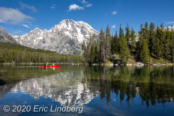 Reached by a wooded hiking trail, Leigh Lake on calm mornings often reflects the nearby mountain peaks.