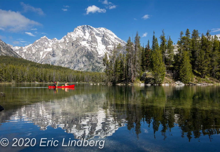 Reached by a wooded hiking trail, Leigh Lake on calm mornings often reflects the nearby mountain peaks.