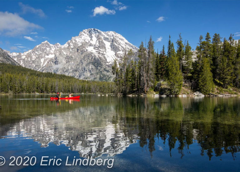 Reached by a wooded hiking trail, Leigh Lake on calm mornings often reflects the nearby mountain peaks.