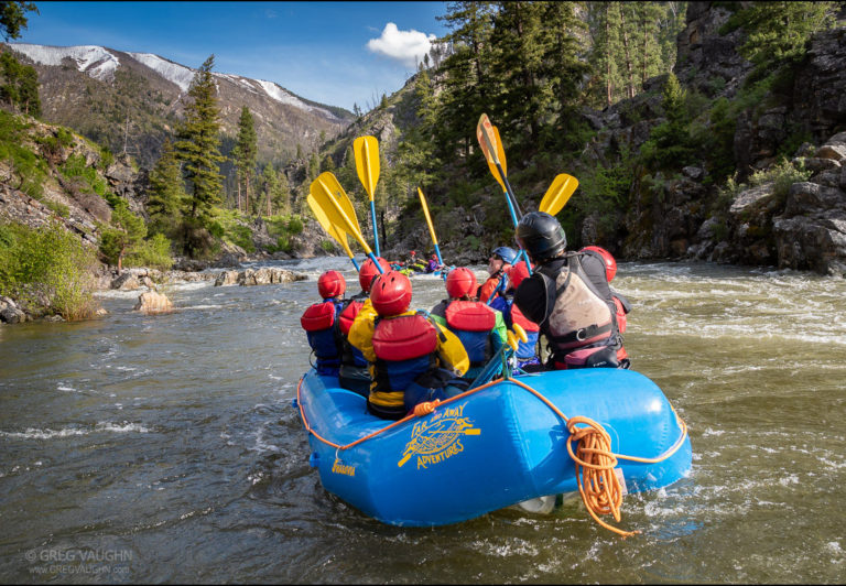 Guide Jake Miczulski and guests celebrate a successful run on the Middle Fork Salmon River with the traditional paddles-up salute.