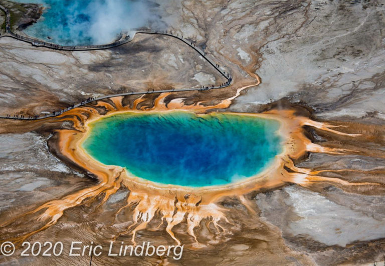 Grand Prismatic Spring is the largest hot spring in the United States and the third largest in the world. The colorful edge of the spring is caused by heat-loving bacteria thriving in the water around the rim.