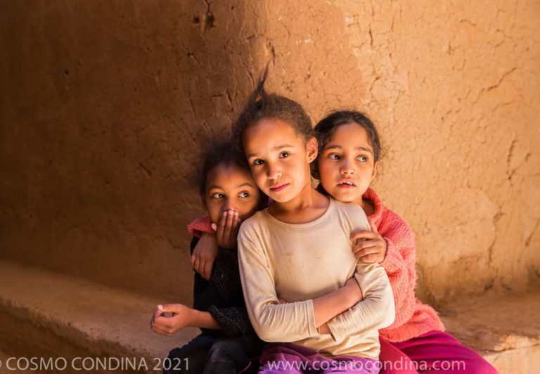 Children posing in Ksar El Khorbat, a fortified village built of mud bricks in the 19th century. in the low valley of Todra, South Morocco.