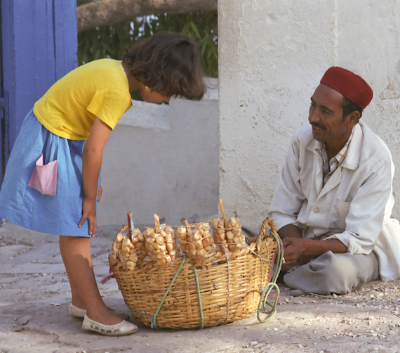 Tunisian girl buying donuts in Sidi Bou Said