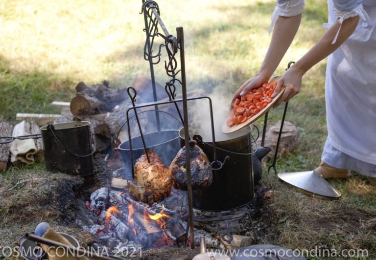 A reenactor prepares an 18th Century lunch over an open fire pit during the siege of Fort Erie.