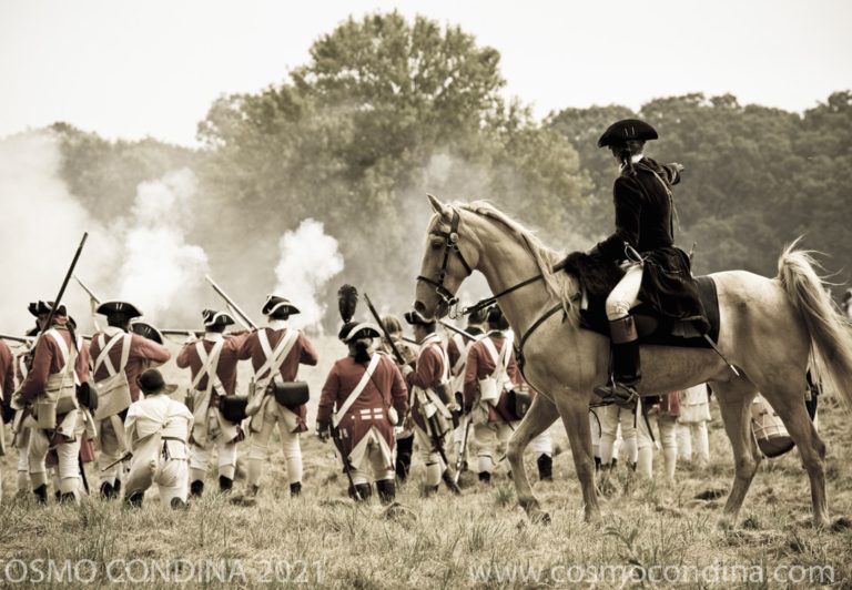 Reenactors portraying American and British troops skirmish in a recreation of the battle for Fort George.
