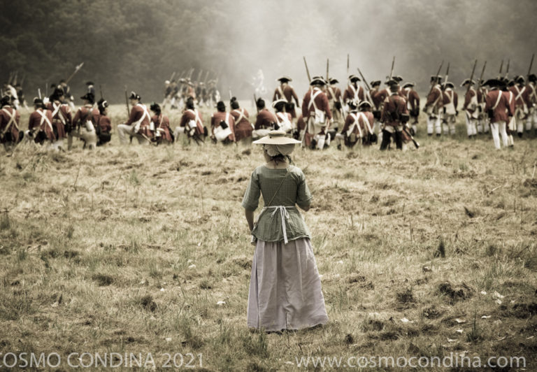 Loyalist woman in period costume watches the reenactment of the fight for Fort George that took place in May 1813.