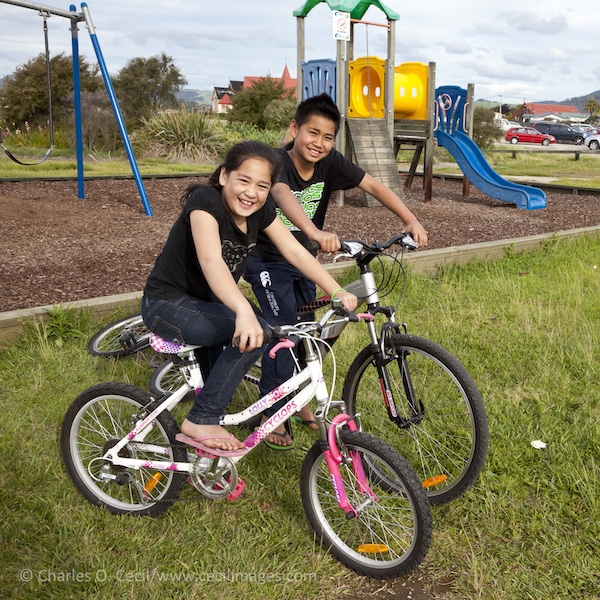 Maori children out for a bicycle ride