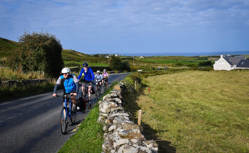 Cyclists bike to the Cliffs of Moher