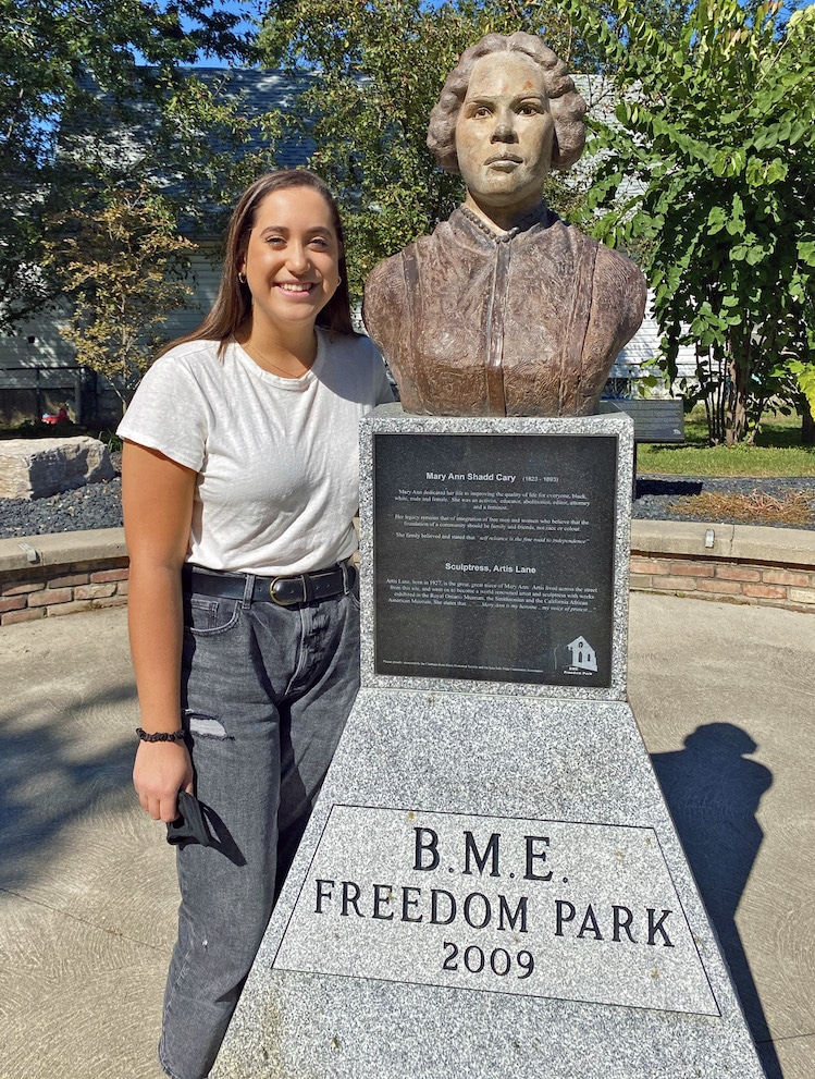 Mia Brooks beside statue of Mary Ann Shadd