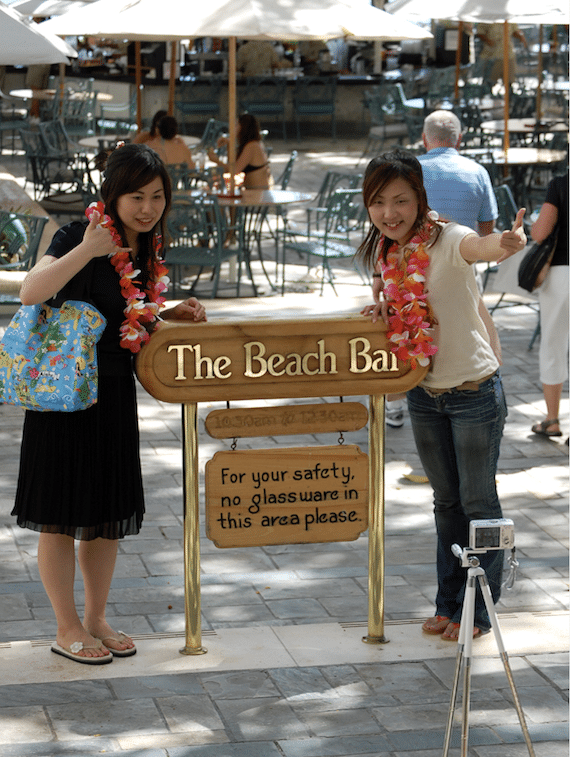 Japanese tourists on Waikiki Beach in Honolulu - International America