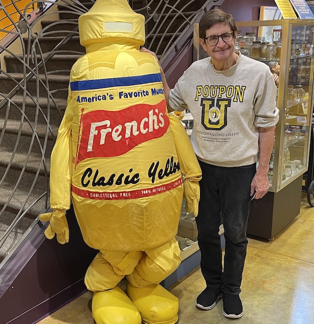 Barry Levenson beside yellow man-sized costume shaped like a French's mustard bottle. Gourmets swear by Dijon, but French's ballpark yellow has a strong following in Middleton, Wisconsin. Photo by David DeVoss 