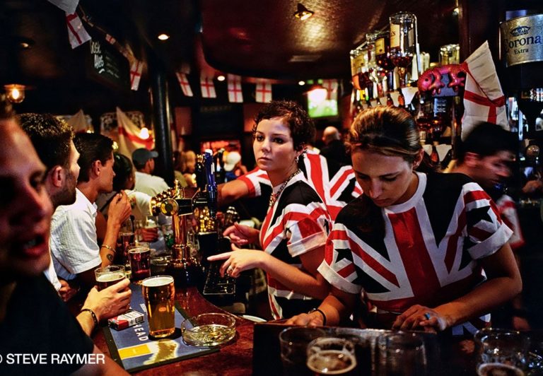 Bartenders-serving-customers-at-bar-counter