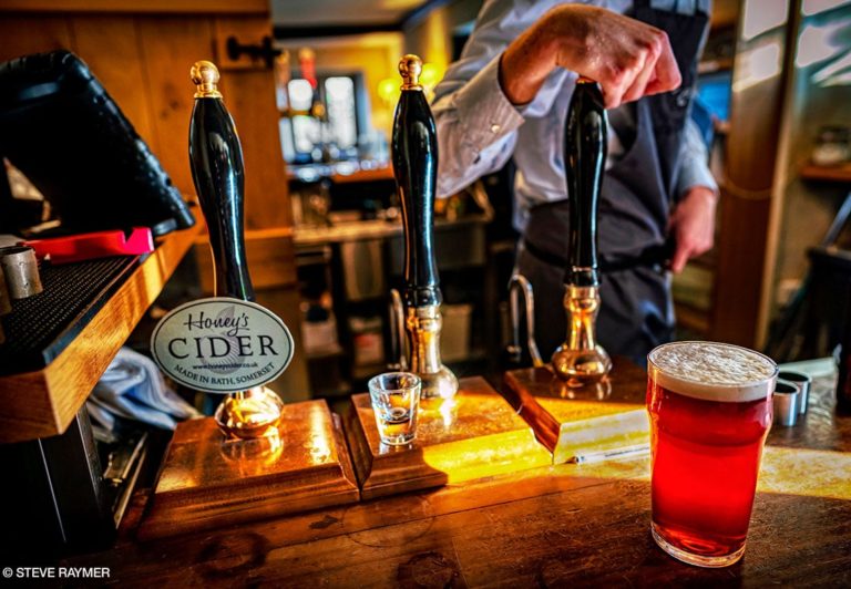 Beer-glass-next-to-Honeys-Cider-tap