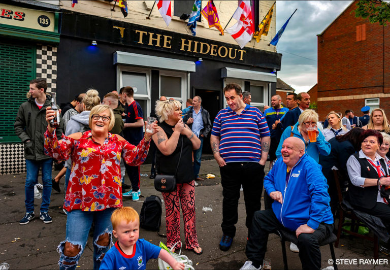 Crowd-of-People-Drinking-and-Talking-Outside-of-The-Hideout