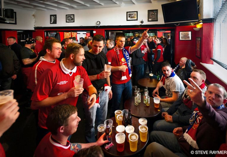 Crowd-of-men-drinking-and-talking-indoors