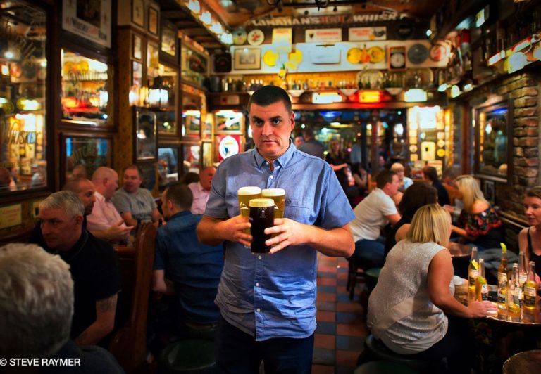 Man-Carrying-Three-Beers-Through-Pub