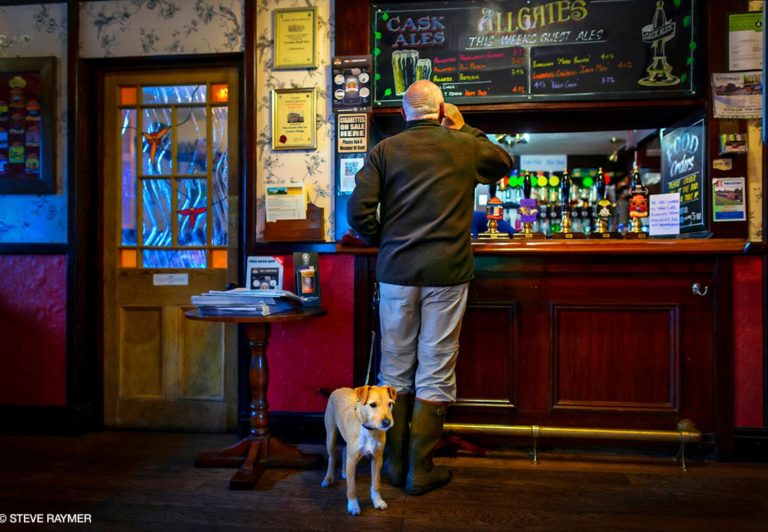 Man-at-bar-counter-with-dog