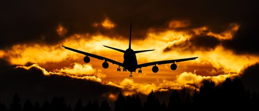 Commercial airliner flies into the sunset