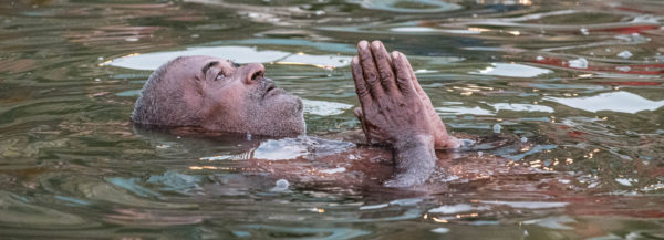 Varanasi, India by Donnie Sexton Man praying in the Ganges River