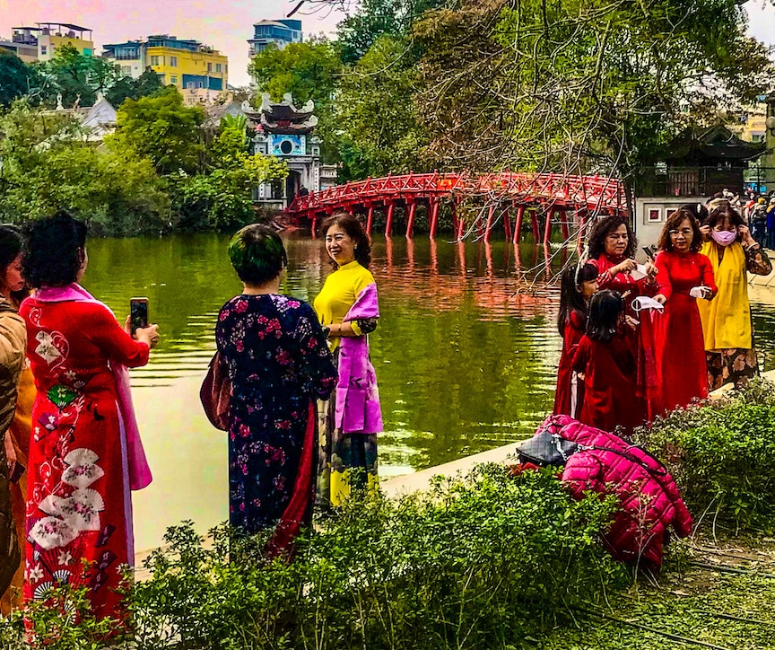 Vietnamese women in ao dai celebrate Tet on the banks of Hoan Kiem Lake in Hanoi