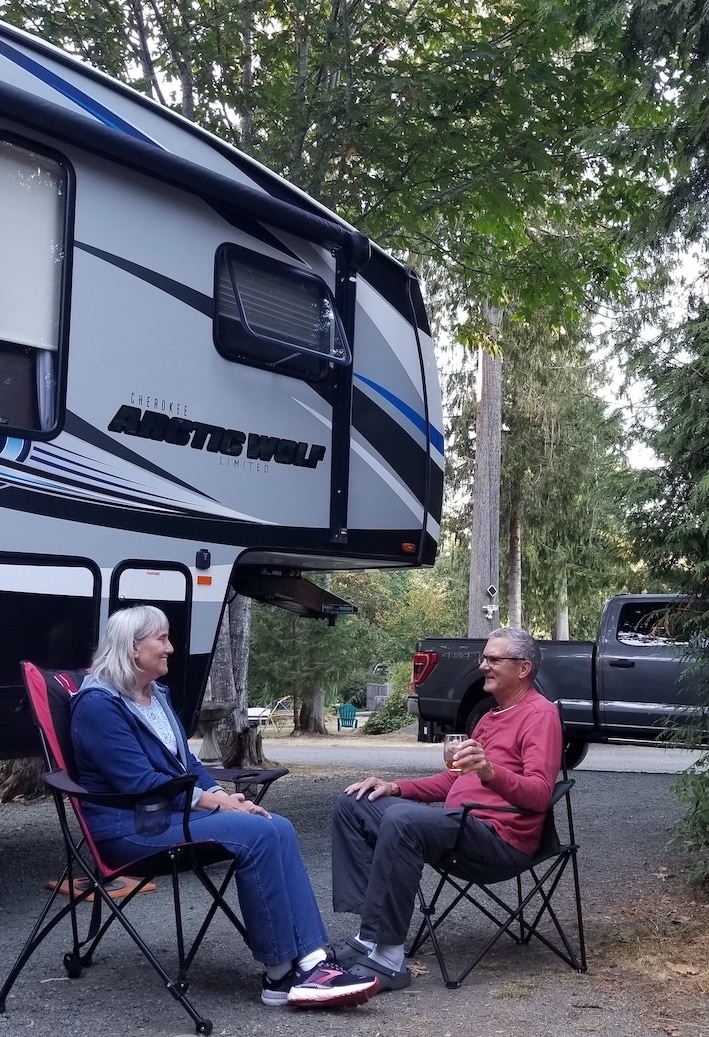 Mark and Grace Fleming beside their 28-ft. Arctic Wolf travel trailer