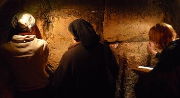 women praying at the Western Wall Tunnels