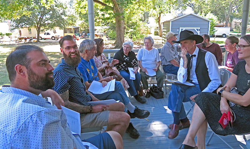 A "French Table" gatheres on the porch of the Valsin Broussard House in Broussard, Louisiana.