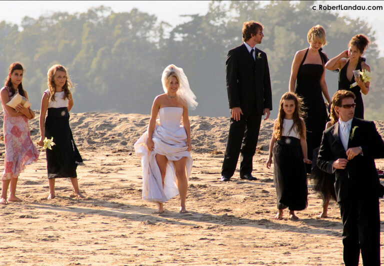 A wedding party gathers on the beach for a photo shoot near the lagoon in Malibu, just outside the historic Adamson House where receptions take place.