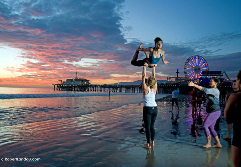 Sometimes luck plays a role in making a compelling image. I was out near the pier in Santa Monica when I came upon a group of people practicing gymnastic moves. The sun had just set so my idea was to frame the action to allow the main figure to be silhouetted against the still bright sky. By coincidence, a flash from another nearby camera went off that exact instance and illuminated the subject in my shot.