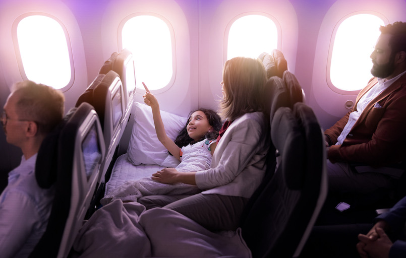 Mother and daughter rest together on a "Skycouch" pioneered by Air New Zealand for use on long-haul flights.