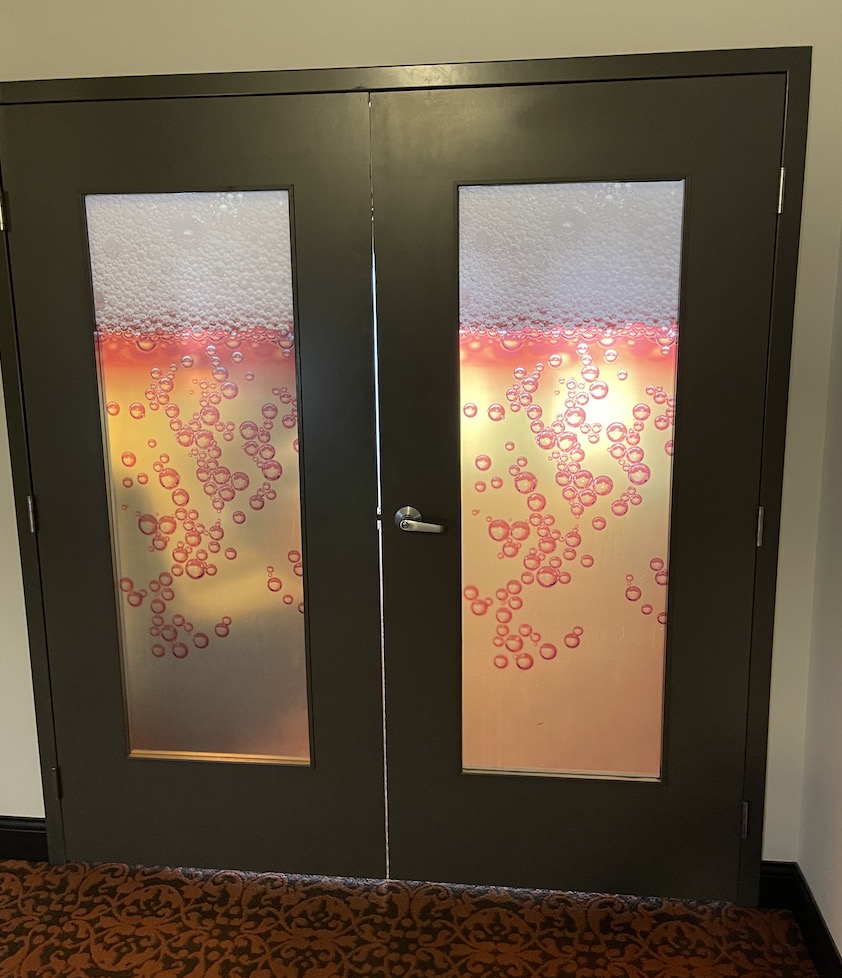 Doors leading into public spaces and off of hallways have an unusual motif at the Brewhouse Inn & Suites in Milwaukee. Glass embedded in the doors is colored and textured to resemble a freshly-poured pint of beer. 