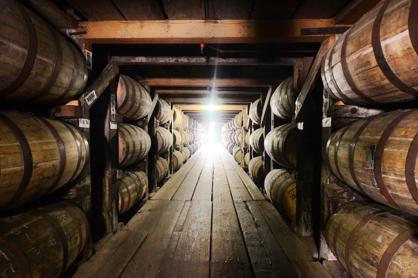 Barrels of bourbon age in charred barrels in a Kentucky rickhouse.