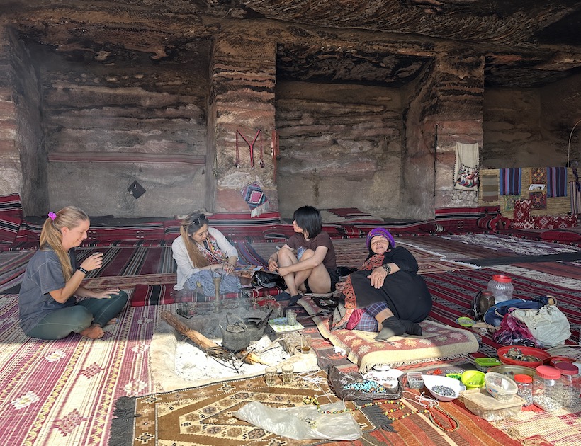 Bedouin women drinking tea with tourists.