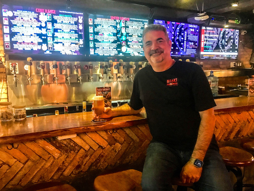 John Pemberton enjoys a cold beer at the Heart of Darkness brew pub in Saigon.