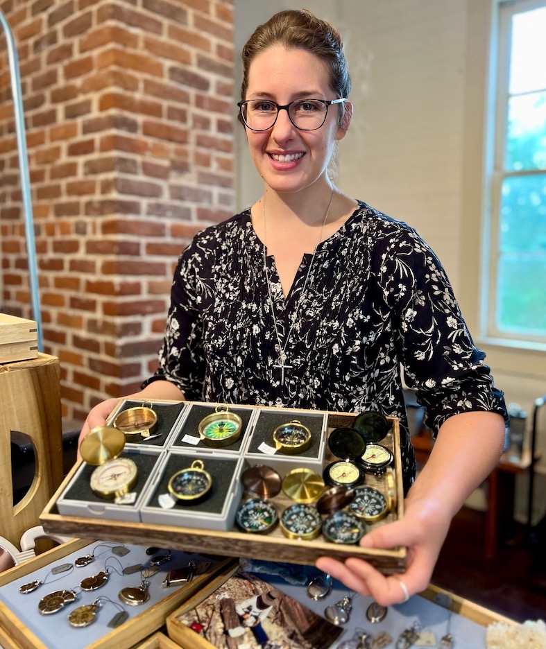Jewelry designer Catherine Rouchon sells antique compasses and other items at the Old Market Hall in St. Francisville.