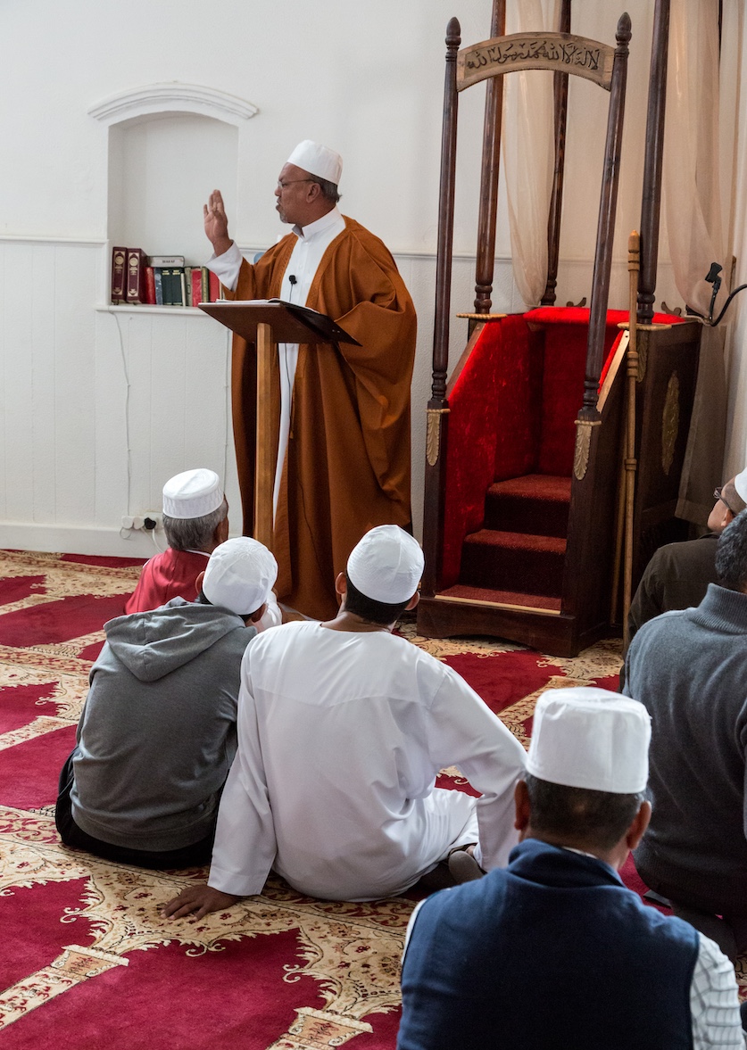 A South African imam satnding in front of his minbar gives the Friday sermon before prayers begin.