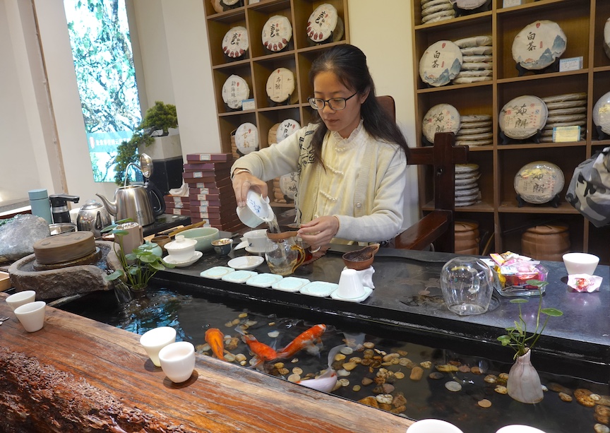 Baixu Fong sells tea, silver and jade on Xianwen Alley (also called Influencers Lane) in Lijiang.