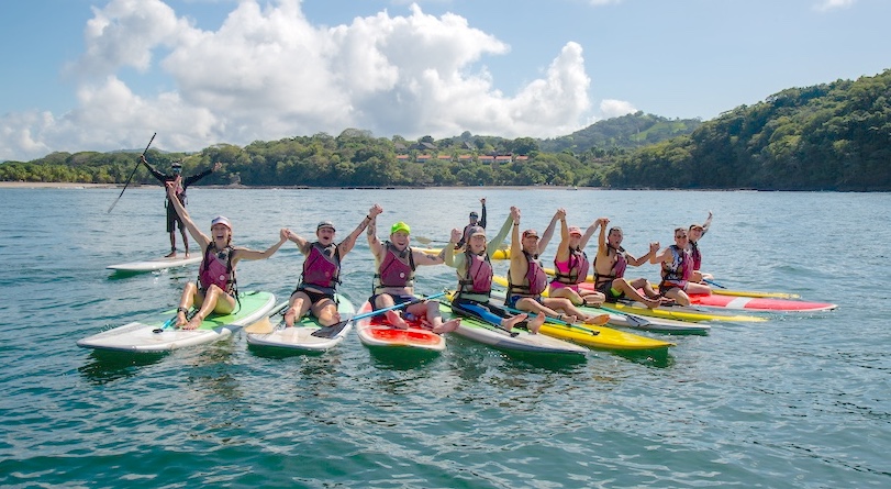 Hanging out on paddle boards with a Choose Life Sober Adventures group tour in Costa Rica.