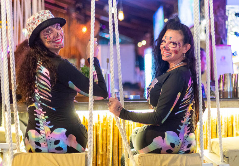 Two ladies at a swing bar dressed as skeletons. There are plenty of bars along Avenida Hidalgo.