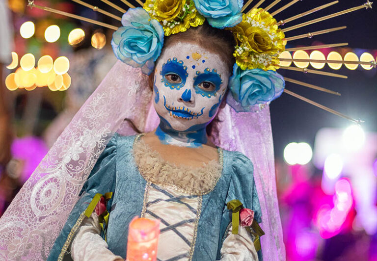 Día de los Muertos costumes on Isla Mujeres are quite elaborate. A custom made dress, elaborate face painting and battery operated lights give this radiant little girl a unique costume.