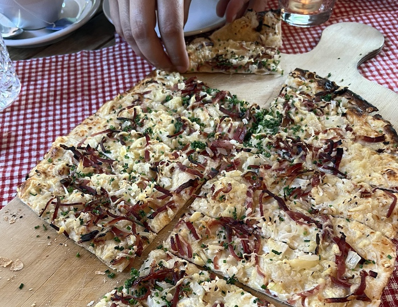 Flammkuchen is the Black Forest's version of pizza, topped with bacon, cheese and other goodies.