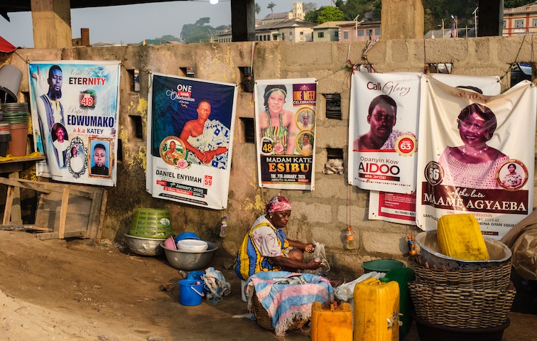 Posters in memory of the recently deceased on display in Elmina, Ghana.