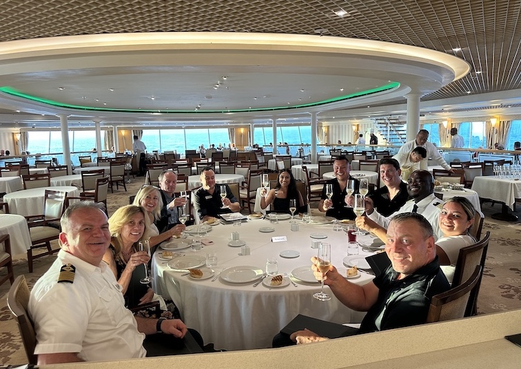 Odyssey Captain Valentin Giuglea hosts a lunch for a group of cruise pasengers in the ship's Thistle Restaurant. Seated to the captain's right are VVR founder Mikael Petterson and corporate CEO Kathy Villalba.