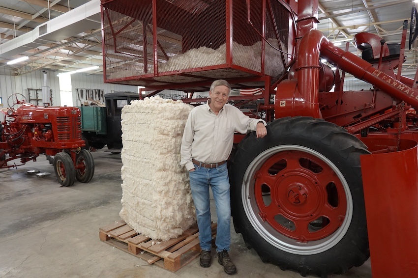 National Agricultural Center and Hall of Fame president David Hurrelbrink stands beside an IH Model 14A Cotton Picker in the Center's Museum of Farming.