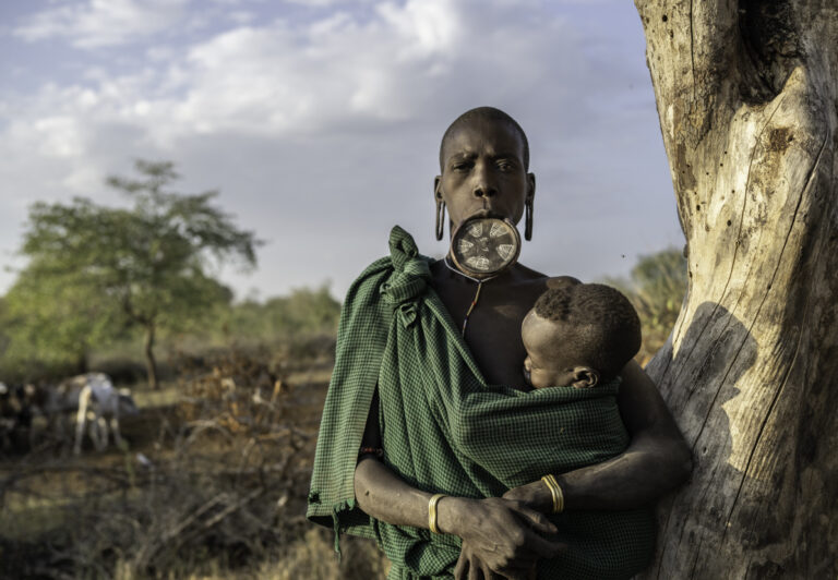 The women of the Mursi tribe are famed for wearing a large wooden or clay plate placed into a cut in their lower lip. It is a teenage girl’s choice to have her lip pierced, not something forced on her by older members of the tribe.