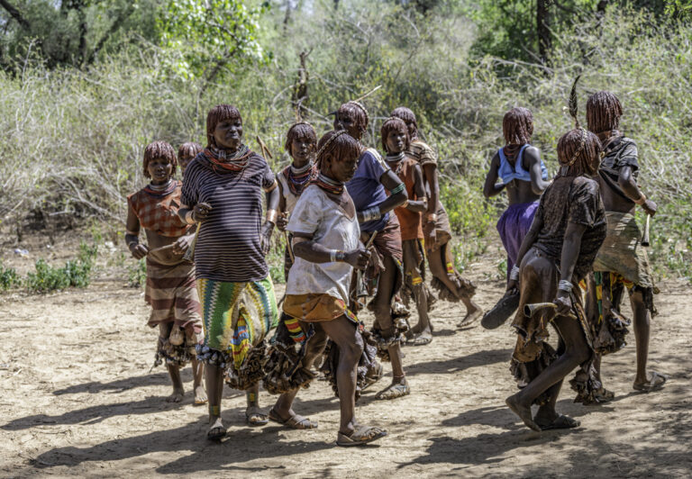 Before the Hamar bull-jumping ceremony starts, the women of the tribe engage in a wild frenzy of dancing, shouting, and blowing horns in a show of respect and love for their kin.